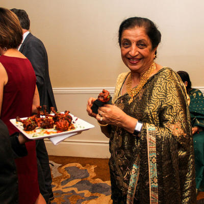 An older indian lady sampling food