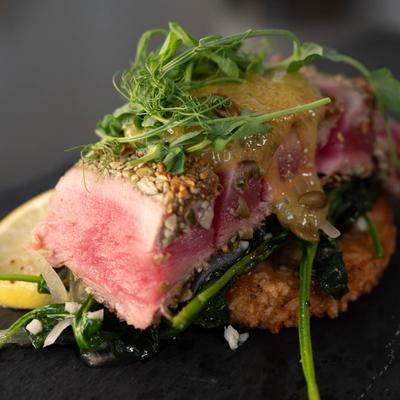 Pepita Encrusted Yellowfin Tuna, with basmati rice cake, spinach, and pumpkin foam.