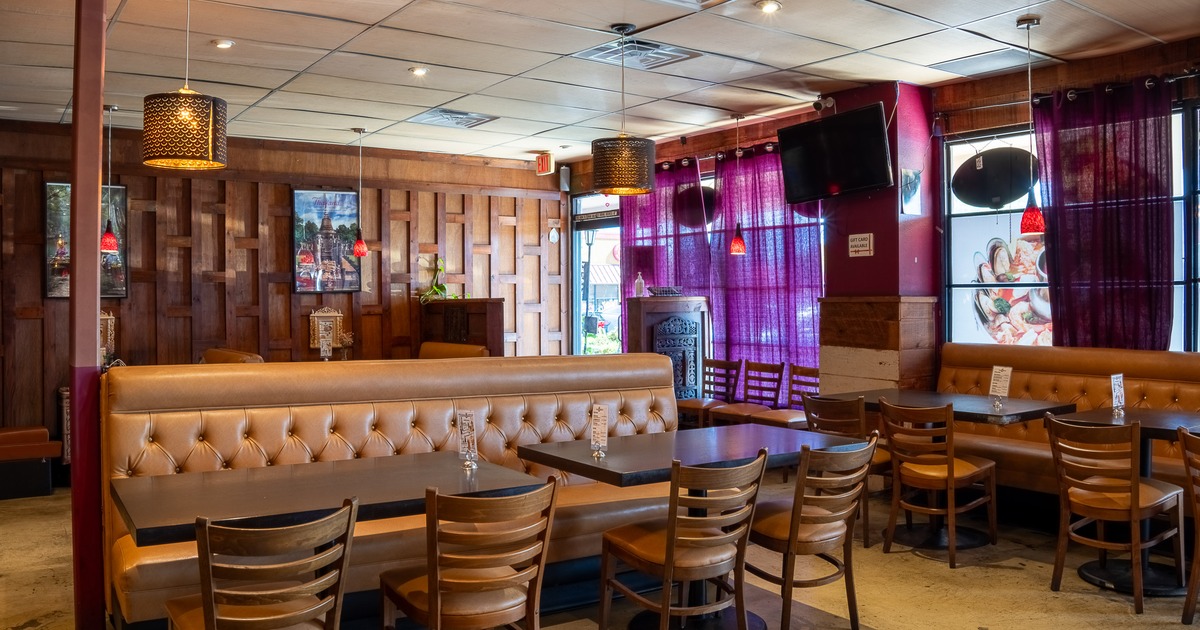 Cozy interior seating area with tables, chairs and upholstered seats
