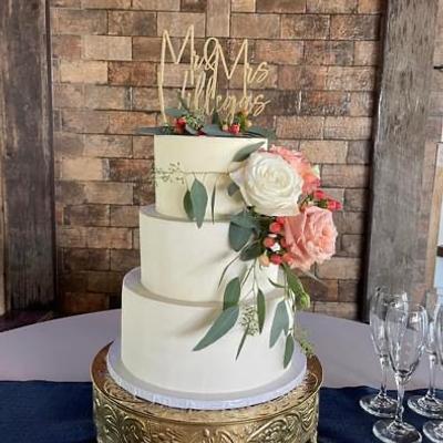 White three tiered  cake with floral decoration