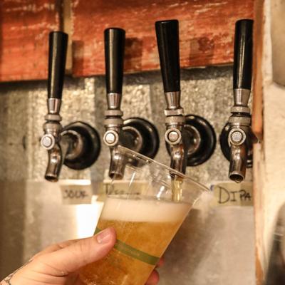 A hand pouring beef from the dispensary.