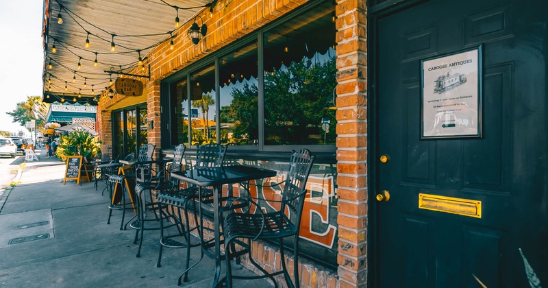 Exterior, high chairs and tables by the window