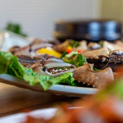Close-up of crab claws and other seafood on a plate with lettuce leaves.