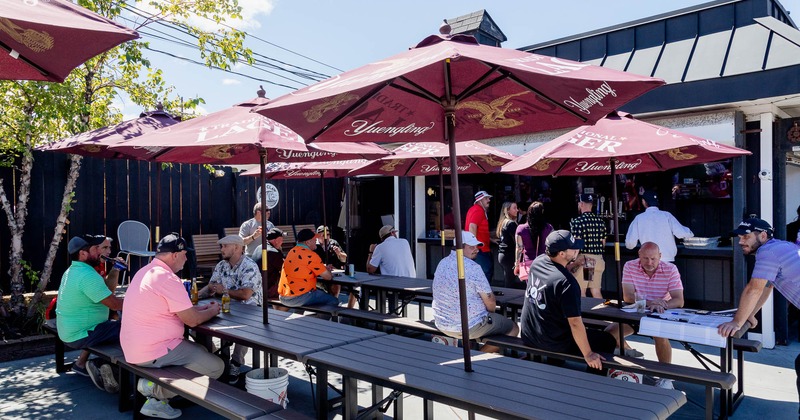 Exterior, tables and chairs full of guests