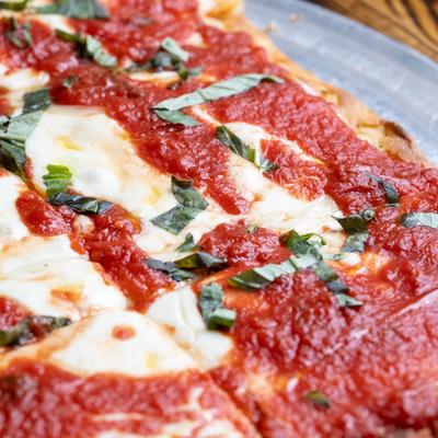 Square pizza, with mozzarella, and tomato sauce.