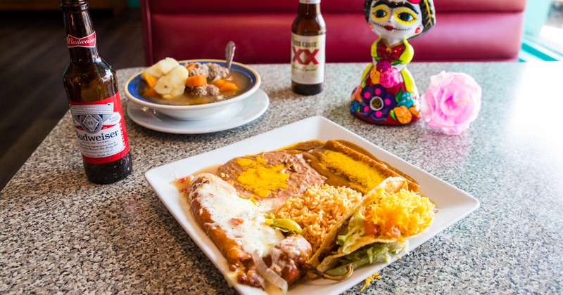 Chile relleno plate, bottled beers and Meatball soup served
