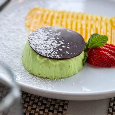 Pistachio panna cotta covered with chocolate.