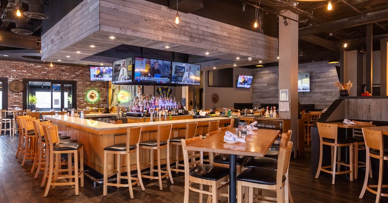 Interior, high tables and bar stools, bar area in the back