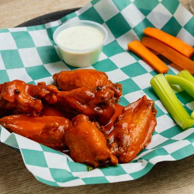 Buffalo chicken wings with ranch, celery, and carrots.