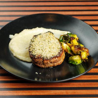 Parmesan crusted Filet Mignon, with mashed potatoes and crispy brussels sprouts.