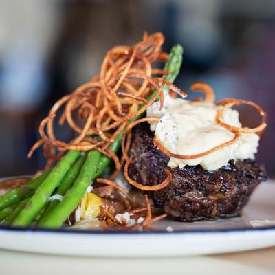 Filet mignon with onion strings and asparagus.