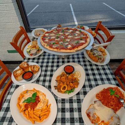 Assorted Italian dishes arranged across checkered table.
