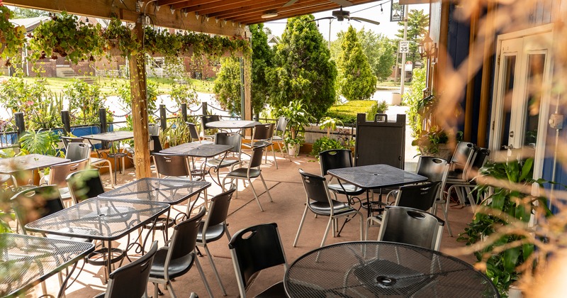 Covered patio surrounded by a lot of plants