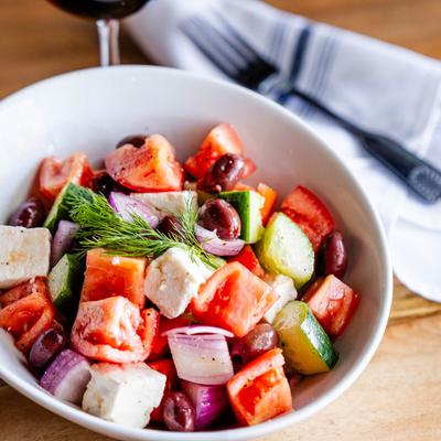 A served Greek salad, angled view.