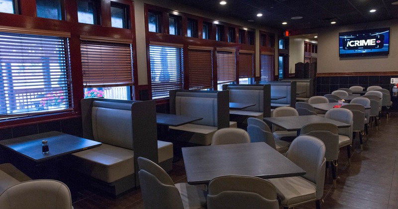 Interior, dining area, seating booths on the lest, tables for four on the right