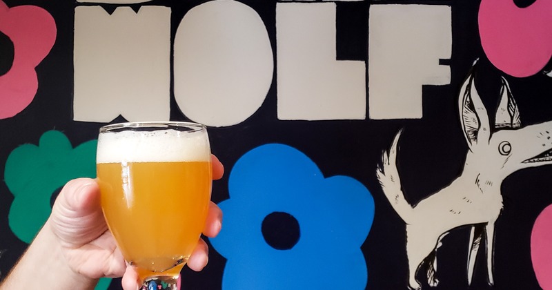 Customer holding a glass of beer