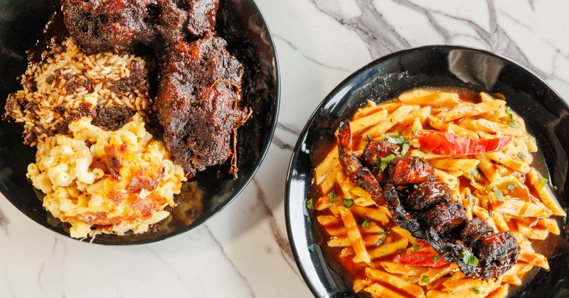 Oxtails with rice and peas, and mac and cheese, a plate of shrimp rasta pasta