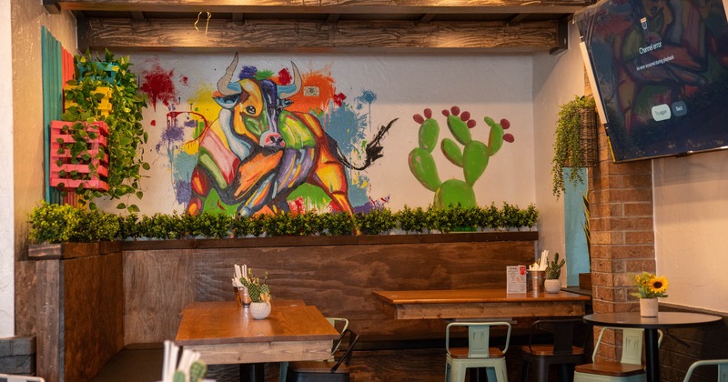 Interior, tables and chairs, TV screen on the wall