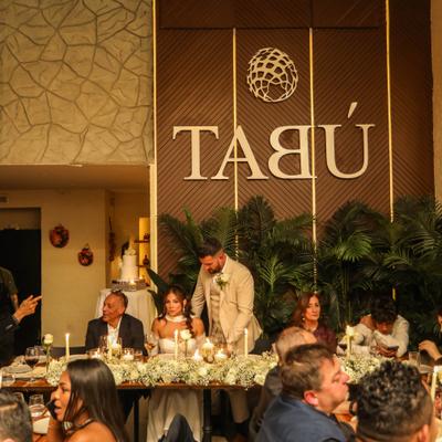 A wedding reception, The bride and groom sit under a 