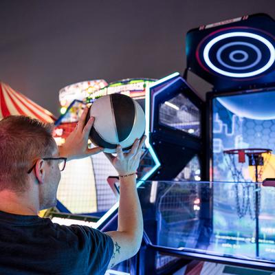 Playing a basketball arcade game.