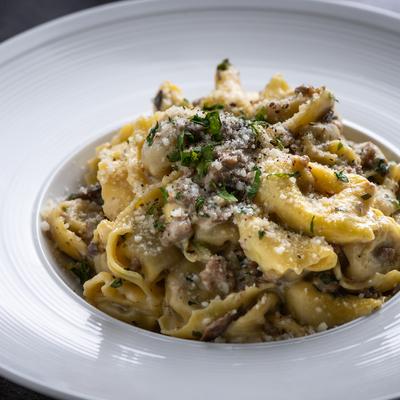Pappardelle with Italian sausage, champignon mushrooms, and cream sauce.