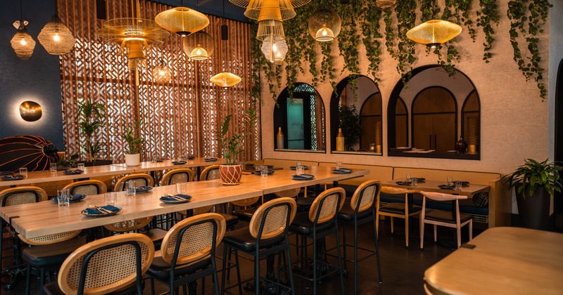 Stylish dining space with woven pendant lights, and warm wood accents
