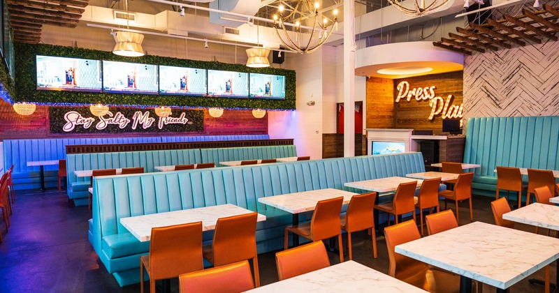 Interior, tables, chairs, upholstered leather benches, lighting, wall LED screens