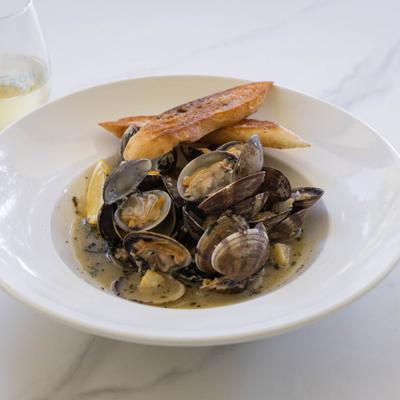 Steamed clams in white wine and butter sauce, served with garlic toast.