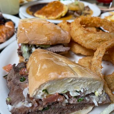 Steak sandwiches, with onion rings.