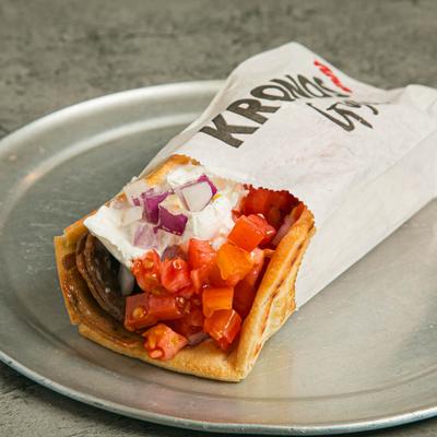 Lamb gyro sandwich, with tzatziki, onion, and tomato.