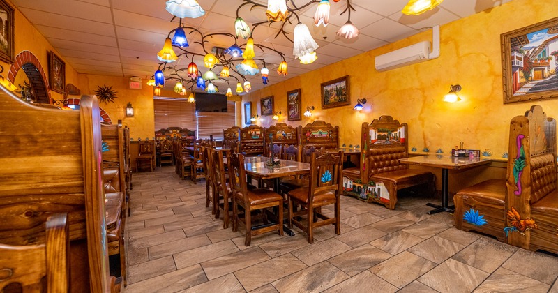 Interior, booths, tables, chairs, decorative lighting, paintings on walls