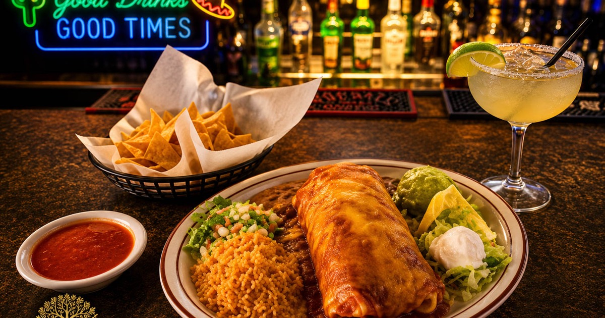 Burrito covered in red sauce, with guacamole, sour cream, tomato salsa, rice, and beans