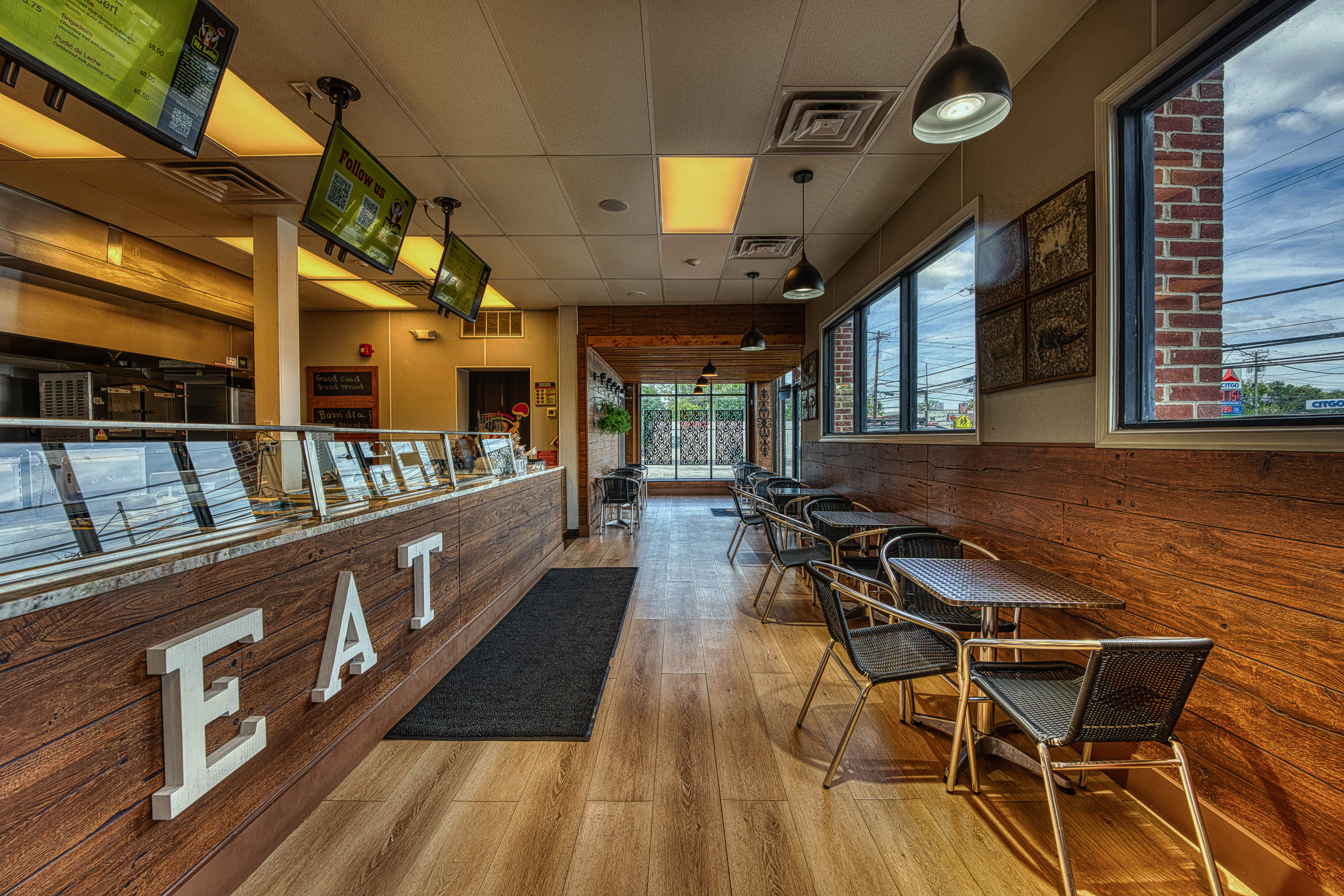 Interior features a counter for ordering, and a dining area with tables and chairs
