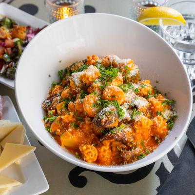 Shrimp pasta with red peppers sauce, grated Parmesan, and parsley.
