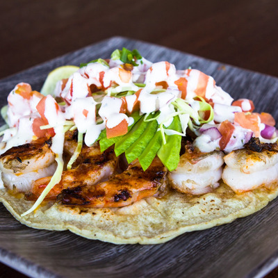 Shrimp with avocado and tomato on flatbread