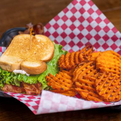 BLT sandwich with side of sweet potato waffle fries.