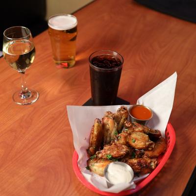 Chicken wings and various drinks.