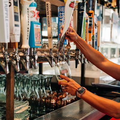 Bartender pouring beer from tap