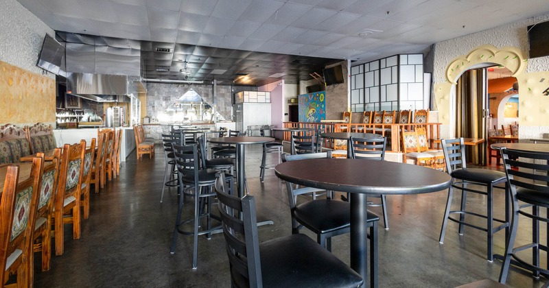 Interior seating area with chairs and circular tables