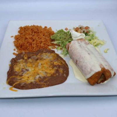Chimichanga plate served with a side of refried beans, rice, and a small salad.
