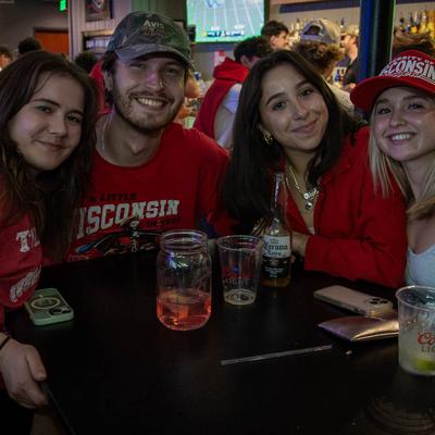 Four people smiling to the camera.