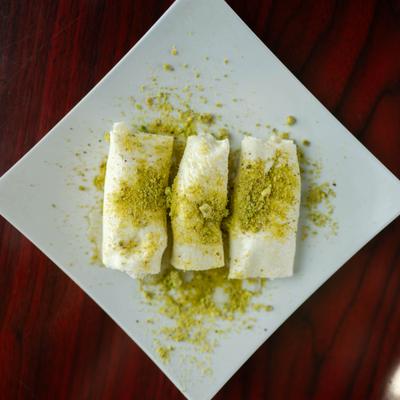 Sweet cheese rolls topped with crushed pistachios.