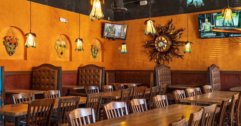 Interior, dining area, wooden top tables for six and eight people, booths in the back
