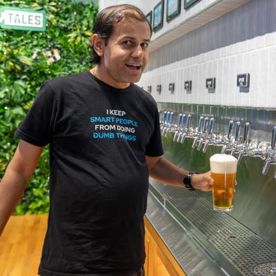 Customer pouring a beer from the tap wall.