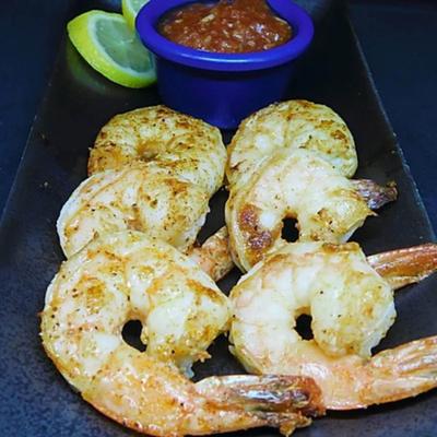 Shrimp dusted in Creole seasoning, served with cocktail sauce.