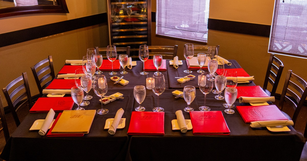 A large dining table at a private dining room set for twelve guests