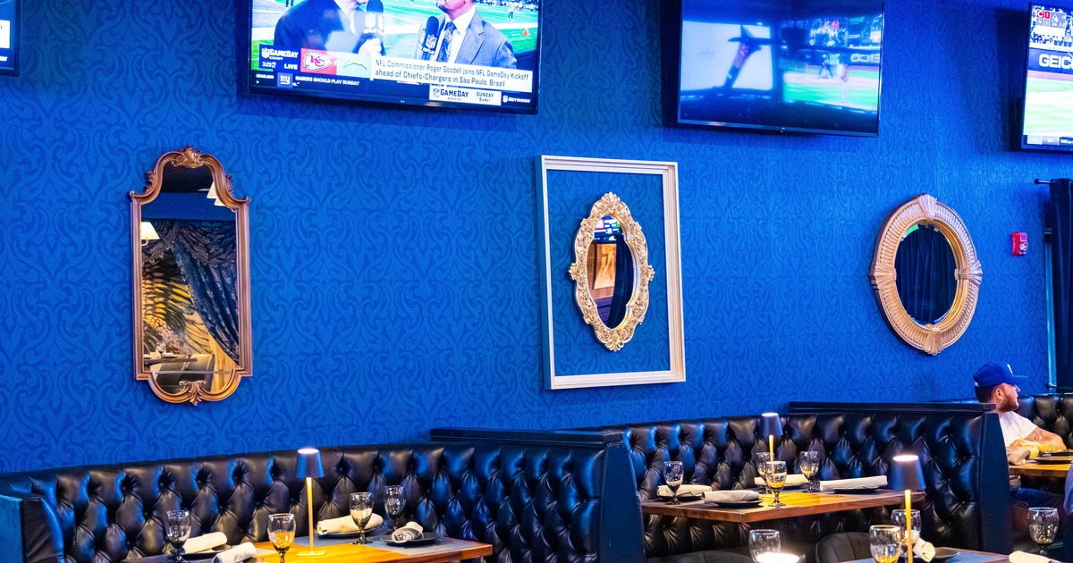 A restaurant interior with blue textured walls