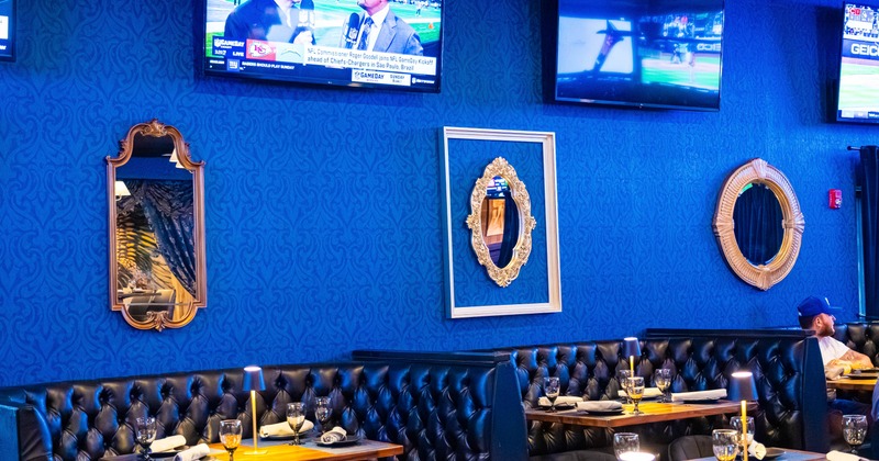 A restaurant interior with blue textured walls