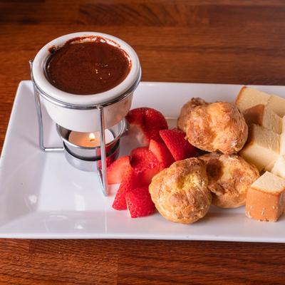 Chocolate Fondue with cream puffs, strawberries, and marshmallows for dipping.