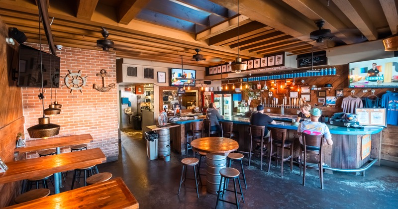 Interior, a bar with bar stools and few guests